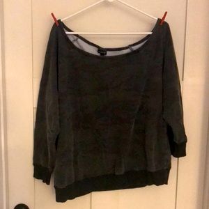 Torrid green and black camouflage off the shoulder sweatshirt.